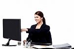 Female Staff Pointing At Monitor Screen Stock Photo