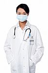 Female Surgeon Posing With Hands In Lab Coat Stock Photo