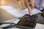 Financial Data Analyzing Hand Writing And Counting On Calculator Stock Photo