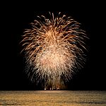 Firework Celebration From The Sea Shore Stock Photo