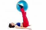 Fit Woman Holding Exercise Ball Between Legs Stock Photo