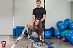 Fitness Instructor Exercising With His Client Stock Photo