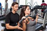 Fitness Instructor Exercising With His Client Stock Photo