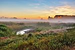 Foggy Summer Meadow In The Morning. Misty Dawn Panorama Stock Photo