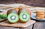 Fresh Kiwi With Cracker On Wood Table Stock Photo