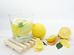 Fresh Lemon In Water And Lemon Slice On White Wood Background Stock Photo