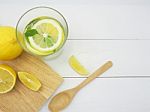 Fresh Lemon In Water And Lemon Slice On White Wood Background Stock Photo