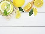 Fresh Lemon In Water And Lemon Slice On White Wood Background Stock Photo