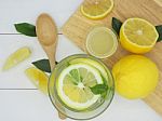 Fresh Lemon In Water, Lemonade And Lemon Slice On White Wood Bac Stock Photo