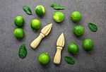 Fresh Limes And Wooden Juicer On White Background. Top View Stock Photo