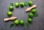 Fresh Limes And Wooden Juicer On White Background. Top View With Stock Photo