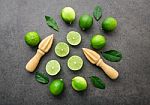 Fresh Limes And Wooden Juicer On White Background. Top View With Stock Photo