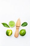 Fresh Limes And Wooden Juicer On White Background. Top View With Stock Photo