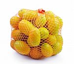 Fresh Orange In Plastic Netting Sack On White Background Stock Photo