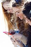 Friends Chatting With Their Smartphones Stock Photo