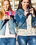 Friends Chatting With Their Smartphones Stock Photo