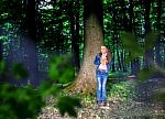 Frightened Little Girl In The Woods Stock Photo