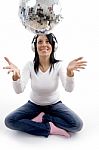 Front View Of Smiling Female Playing With Disco Mirror Ball Stock Photo