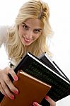 Front View Of Smiling Student Holding Course Books Stock Photo