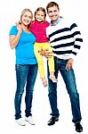 Full Length Portrait Of A Cheerful Family Of Three Stock Photo