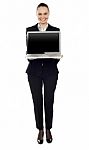 Full Length Portrait Of Woman Presenting New Laptop Stock Photo