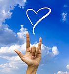 Gesturing Hand On Blue Sky Stock Photo