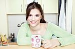 Girl And Tea Cup In Kitchen Stock Photo