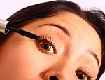 Girl Applying Mascara Stock Photo