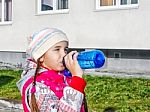 Girl Drinking Water From A Bottle On The Street In Autumn Stock Photo