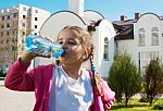 Girl Drinks Water From A Plastic Bottle Stock Photo