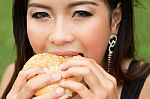 Girl Eating A Cheeseburger Stock Photo