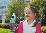 Girl Holding A Plastic Bottle With Water Stock Photo