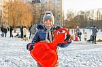 Girl Holding A Sled Stock Photo