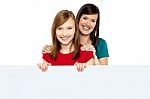 Girl Holding Ad Board With Her Mother Behind Her Stock Photo