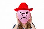 Girl Holding Pink Balloon With Angry Face And Red Hat Stock Photo