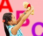 Girl Holding Teddy Bear Stock Photo