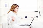 Girl In Bathrobe Chatting On Computer Stock Photo