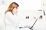 Girl In Bathrobe Chatting On Computer Stock Photo