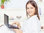 Girl In Bathrobe With Computer Stock Photo