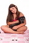 Girl In Swimsuit At The Beach With Dog Stock Photo