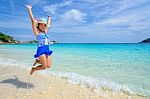 Girl Jumping With Happy On The Beach At Thailand Stock Photo