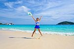 Girl Jumping With Happy On The Beach At Thailand Stock Photo