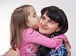 Girl Kissing Her Mother Stock Photo