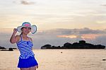 Girl On The Beach At Sunrise Over The Sea Stock Photo