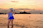 Girl On The Beach At Sunrise Over The Sea Stock Photo