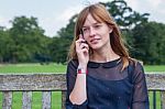 Girl Phoning With Mobile Phone In Nature Stock Photo