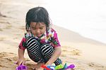 Girl Playing Toy On Beach Stock Photo