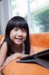 Girl Playing With Tablet Stock Photo