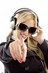 Girl Pointing forward With Earphone Stock Photo