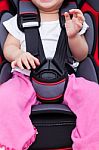 Girl Sitting At Carseat And Fasten Seat Belt Stock Photo